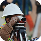 Land surveyor measuring a plot with a theodolite